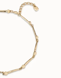 Collar bañado en oro de 18k con piezas en forma de clavo.
