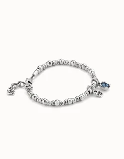 Pulsera bañada en plata de ley con perla y cristal azul.