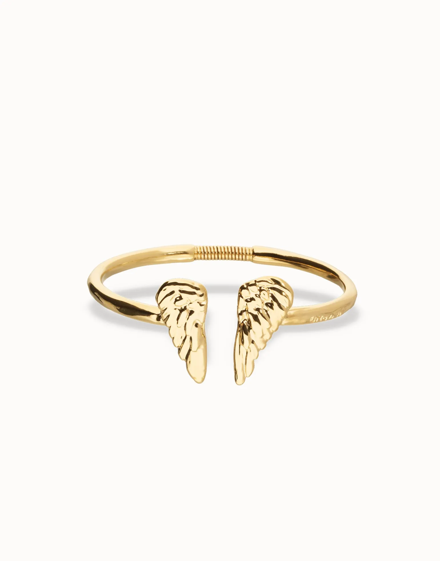Pulsera rígida bañada en oro 18k con detalle de alas